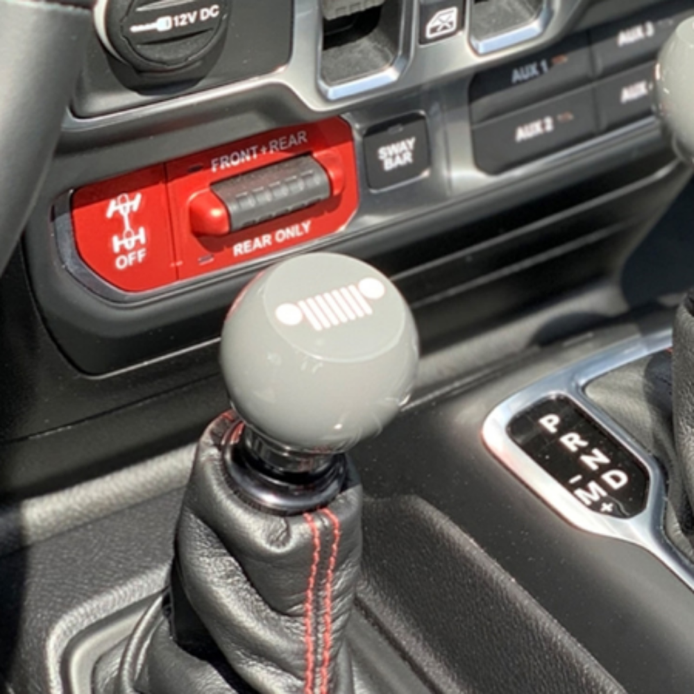 "Enhance your Jeep's shifting experience with this flat top billet shift knob, shown in gray, for 2018+ Wrangler.